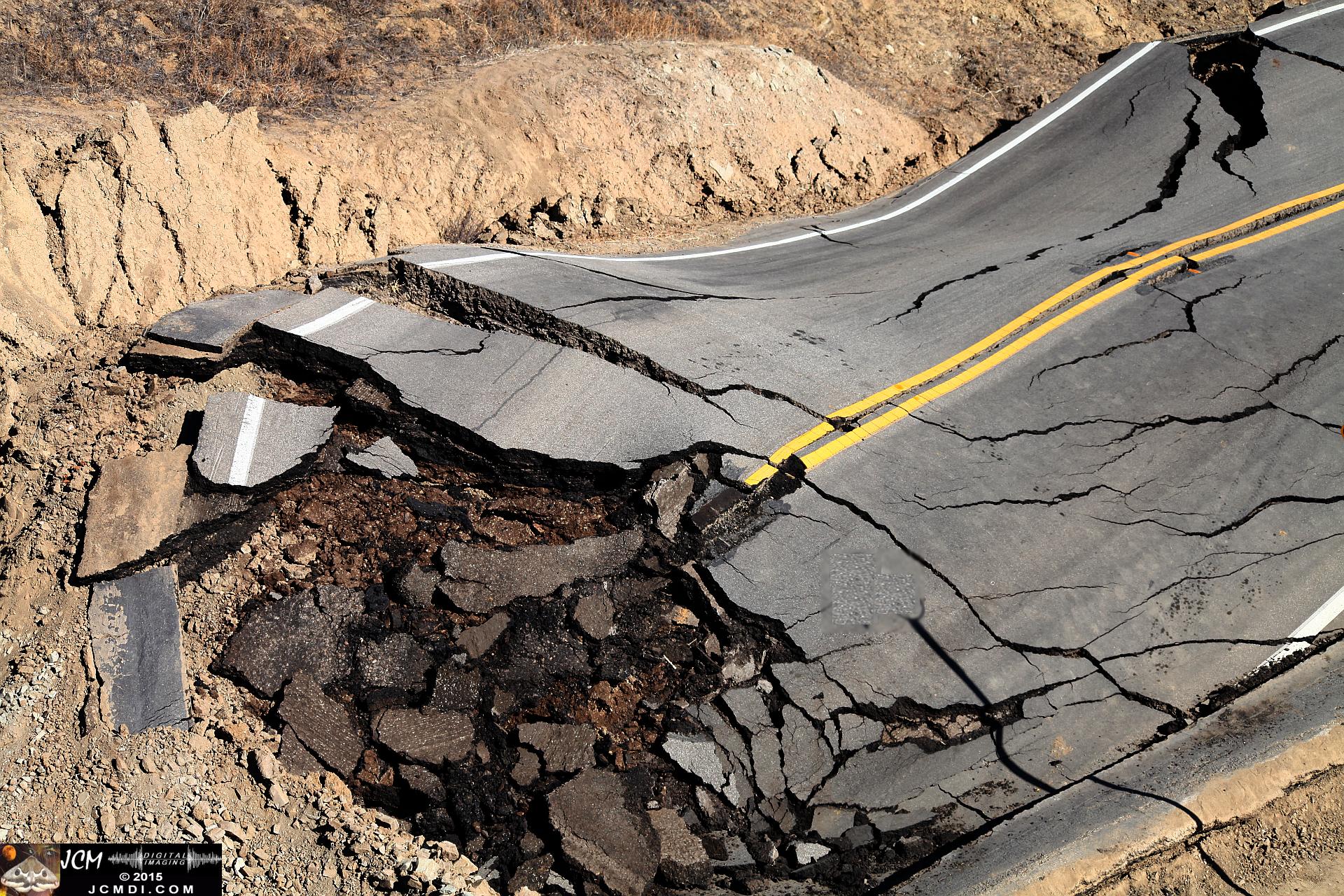 Landslide, buckled pavement, and terrain at Vasquez Canyon Road in Santa Clarita, CA filmed 11-25-2015